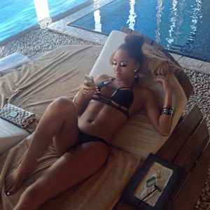 black-american-girl-in-crazy-bra-and-bikini-lies-on-indoor-beach-couch